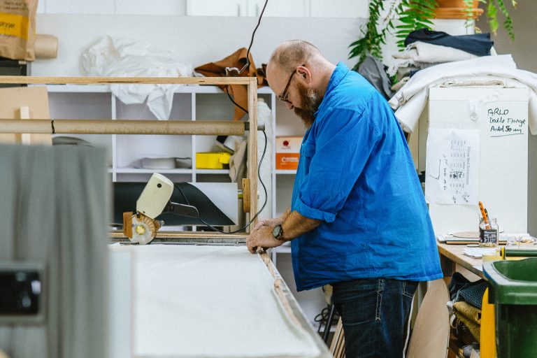 Upholsterer working on custom furniture in the Bluestone workshop, Melbourne