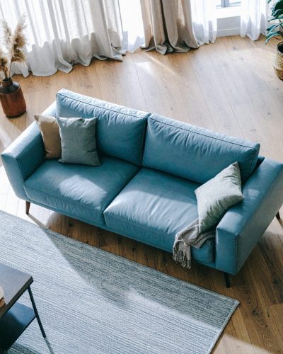 Firefly_Place this modern grey leather sofa in a warm, naturally lit interior with oak wood f 707961